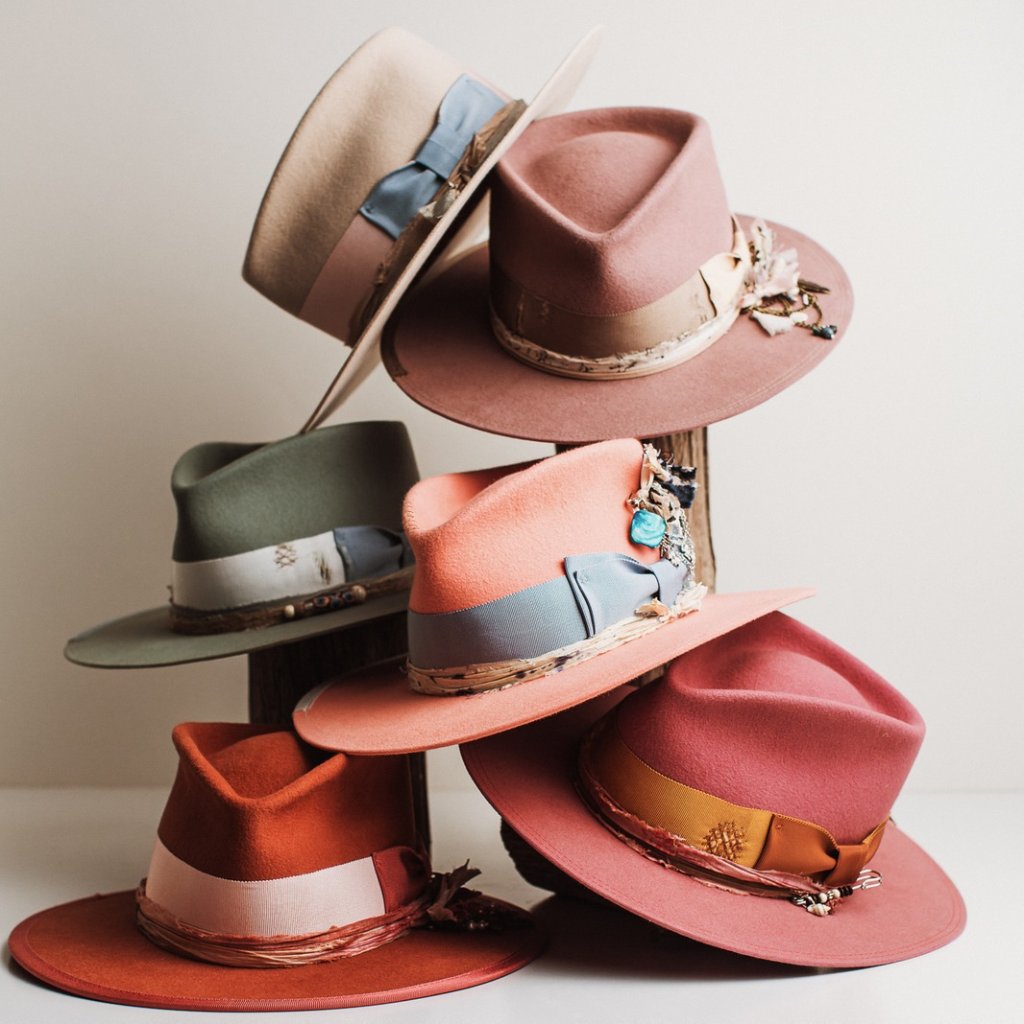 A rainbow mix of pastel and bright felt hats from PHYLLi Designs Candy Shop collection, each styled with playful trims and layered trimmings