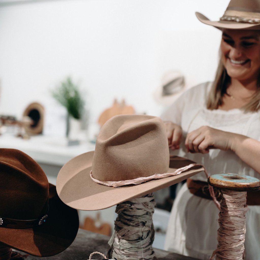 Custom hat styling experience at PHYLLi Designs with trims and accessories
