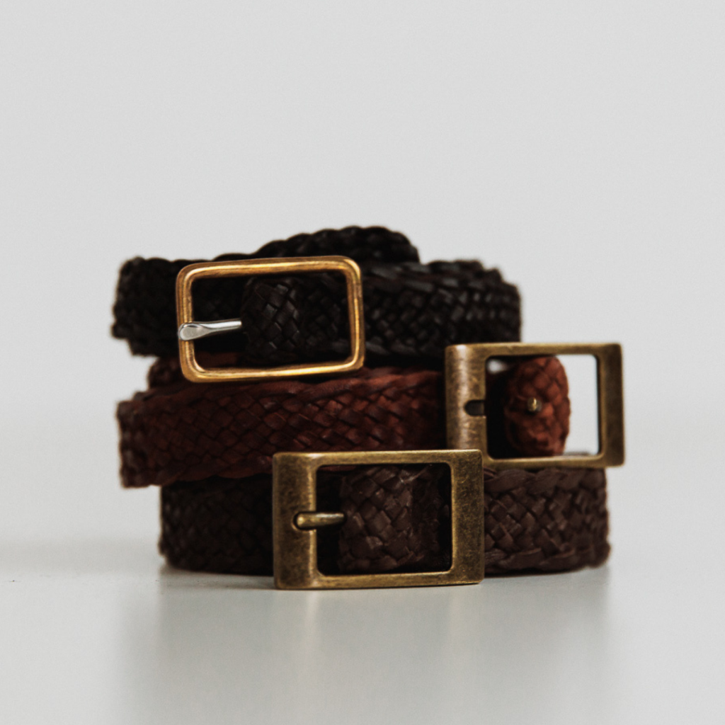 Stack of dark brown plaited leather hat bands with antique bronze buckles, handmade in Australia by PHYLLi Designs