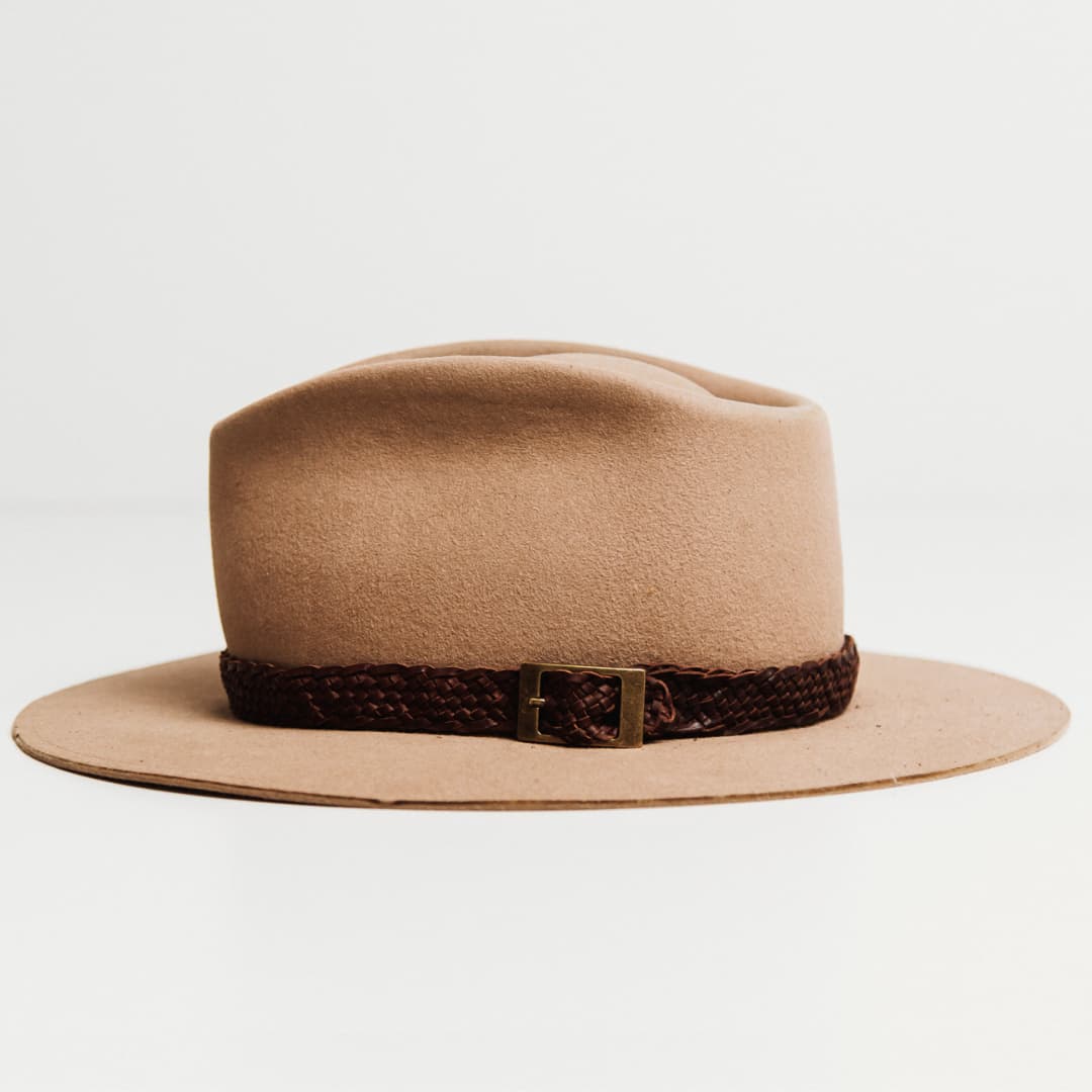 Left side view of the 12 Strand Plaited Hat Band featuring chestnut plaited kangaroo hide and antique bronze buckle detailing on a Sahara felt hat by PHYLLi Designs.