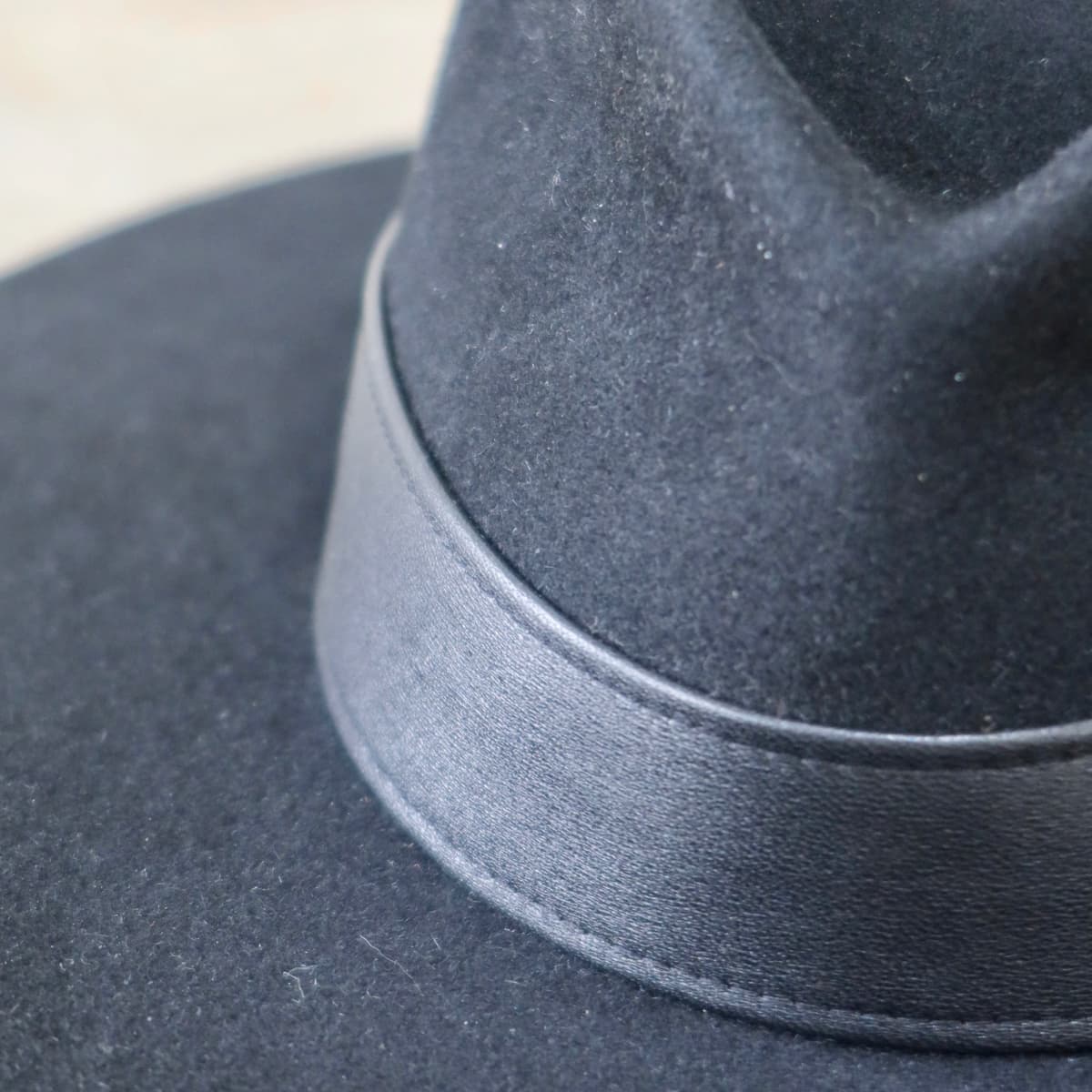 Close up detail of the Kirrilee felt hat showing handcrafted sheepskin leather band.
