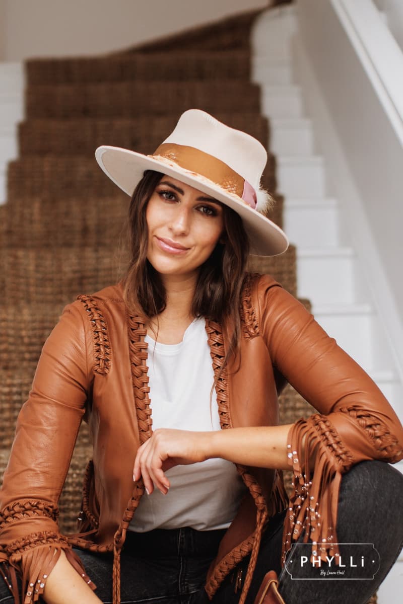 Woman wearing the Malibu beige felt hat by PHYLLi Designs with copper grosgrain band.