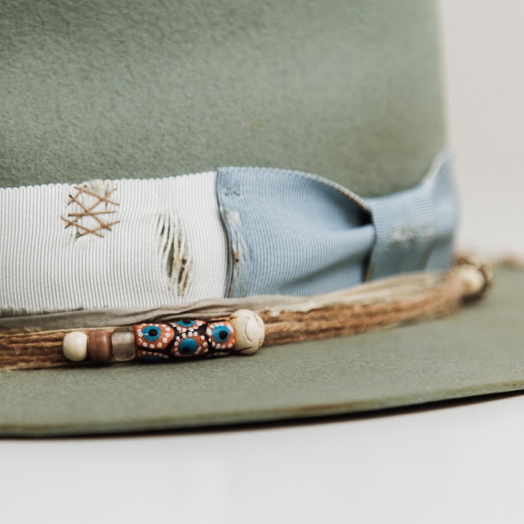 Close up detail of the Accra felt hat showing sari silk trimming in steel blue and peach.