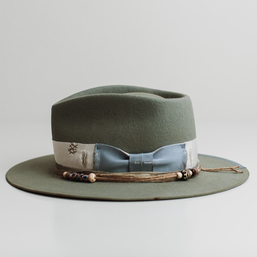 Left side view of the Accra sage felt hat by PHYLLi Designs with cornflower Japanese grosgrain 1/3 brim trim and double brim stitch.