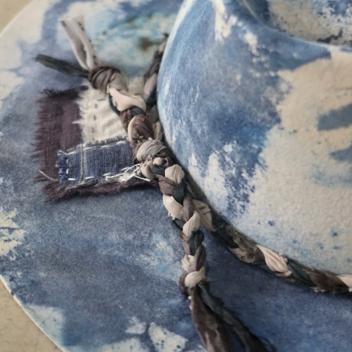 Close up detail of the Aizome Limited Edition felt hat showing wabi sabi linen patchwork stitching.