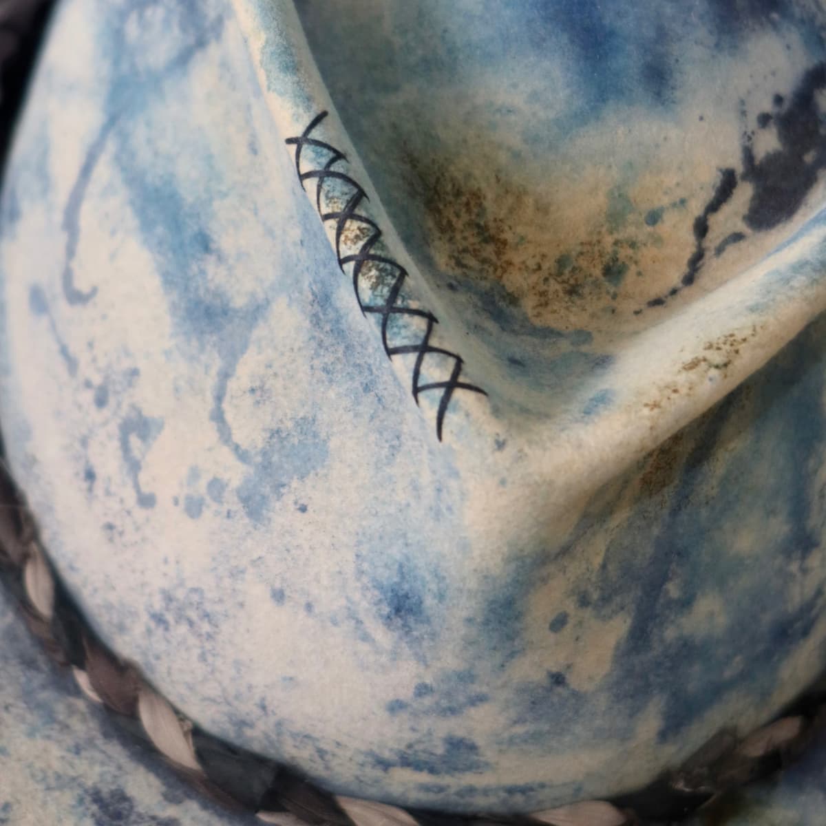 Close up detail of the Aizome Limited Edition felt hat showing hand stitched crosses on the crown.