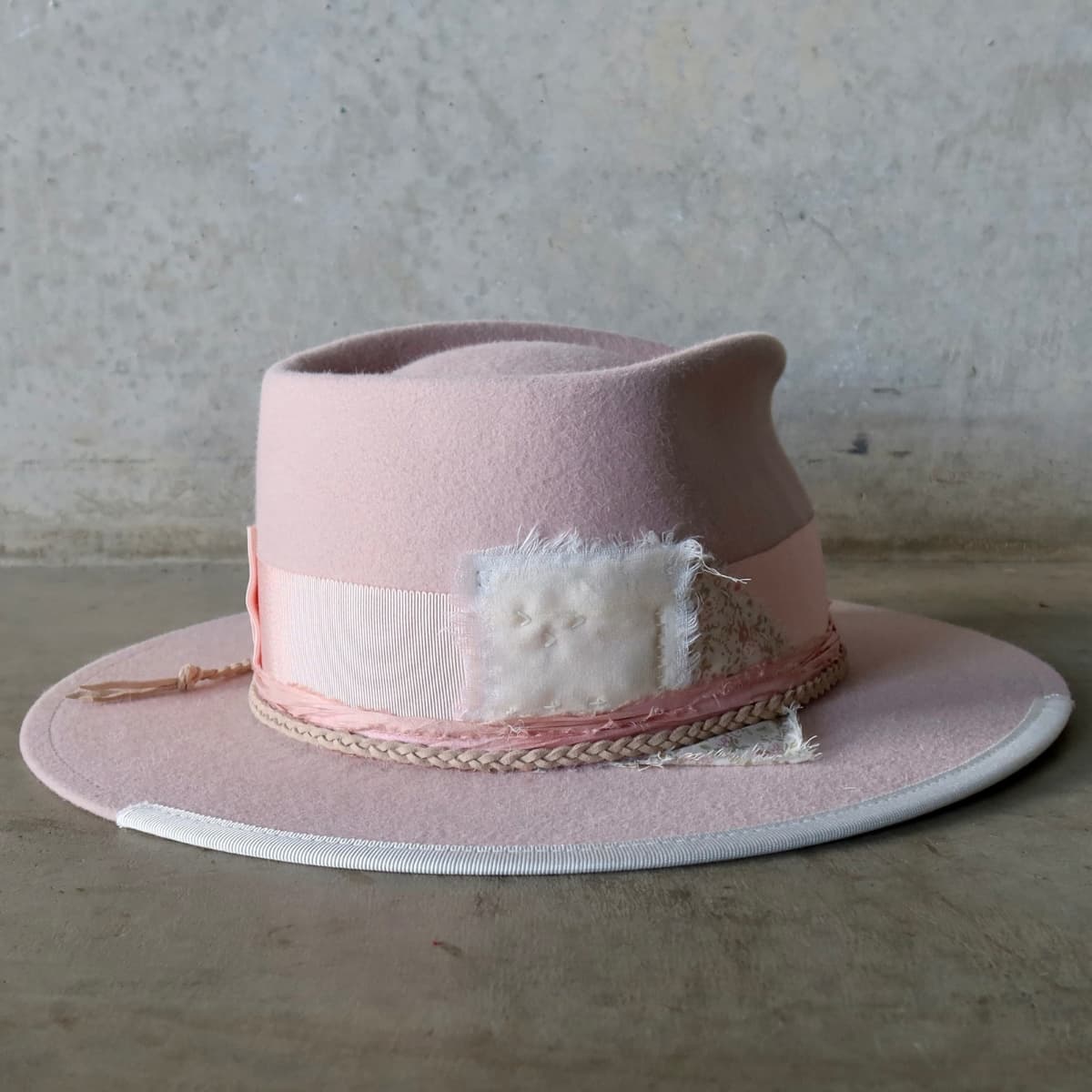 Back right angle of the baby pink felt hat Argyle Limited Edition by PHYLLi Designs showing wabi sabi patchwork in ivory linen, silk and floral cotton trim.