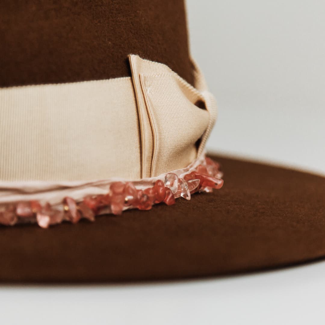Close up detail of the Australis felt hat showing sand Japanese grosgrain double bow band with ballerina pink sari silk trim.