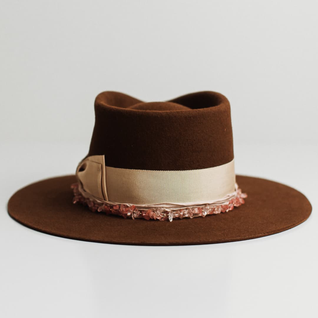 Back view of the Australis caramel felt hat by PHYLLi Designs featuring sand grosgrain double bow band and rose quartz necklace.