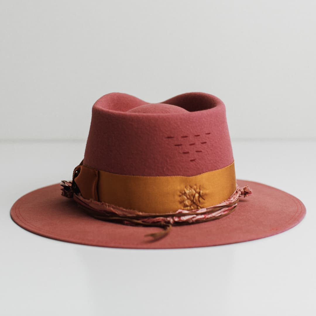 Back view of the Barbados Rose rose felt hat by PHYLLi Designs featuring burgundy hand-stitched lines on the crown.