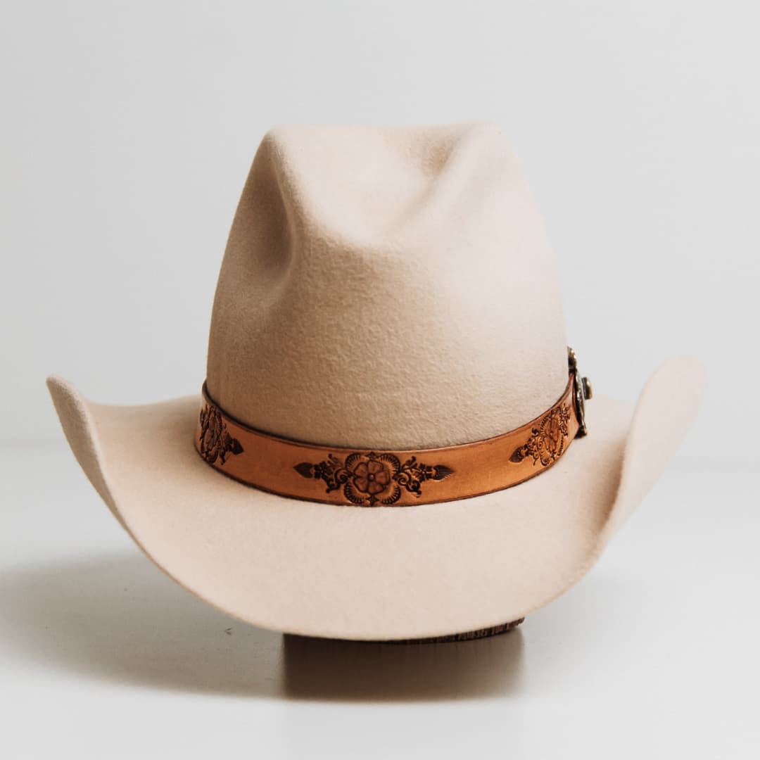 PHYLLi x Buffalo Girl Palamino Mandala Hat Band with Navajo Concho hand tooled Palamino leather Mandala on a beige felt cowboy hat by PHYLLi Designs.