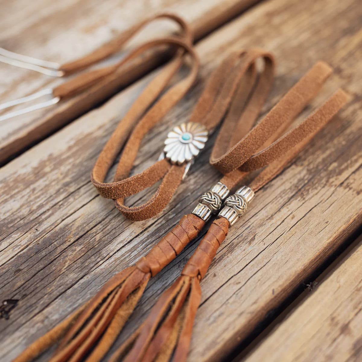 PHYLLi x Buffalo Girl Stampede Strap in tan suede with leather wrap, bead accents and tassel detailing.