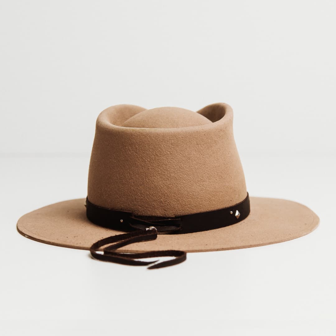 Back view of the Buffalo Tieback Studded Hat Band featuring buffalo hide tieback with brushed silver tieback fasteners on a Sahara felt hat by PHYLLi Designs.