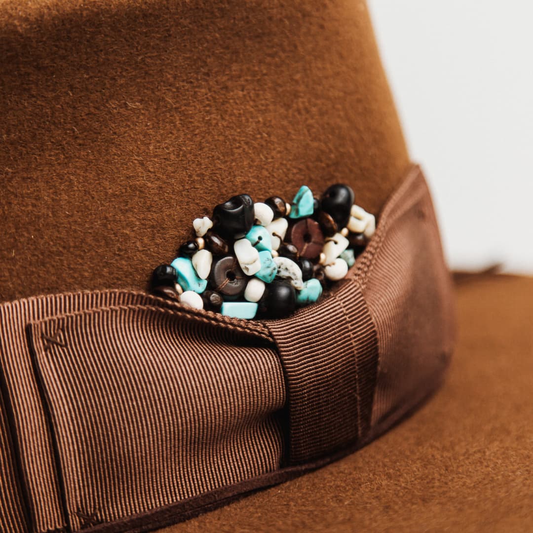 Close up detail of the Calaveras felt hat showing skull bead cluster with bone beads and howlite stones.