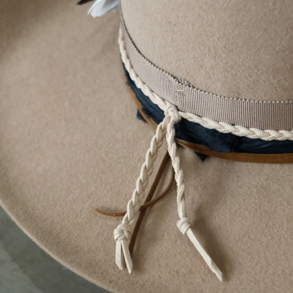 Close up detail of the Casey cowboy hat showing plaited nude suede string and tan suede tie at the back.