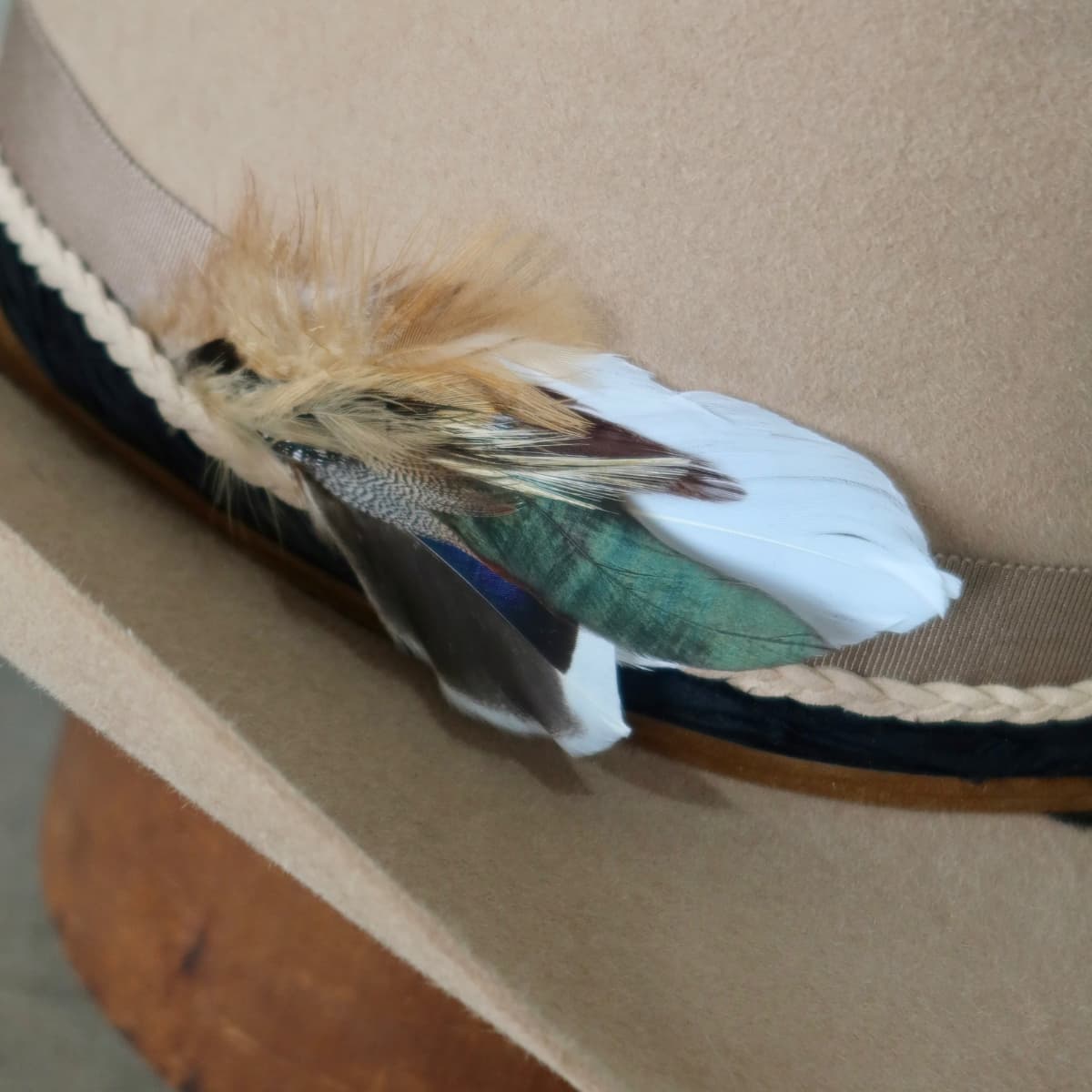 Close up detail of the Casey cowboy hat showing assorted fallen feather bunch with layered sari silk trimming.
