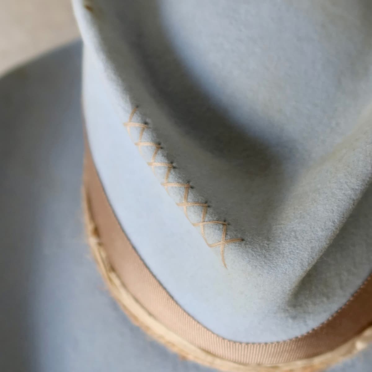 Close up detail of the Clareville Limited Edition felt cowboy hat showing hand stitched crosses in taupe on the crown.