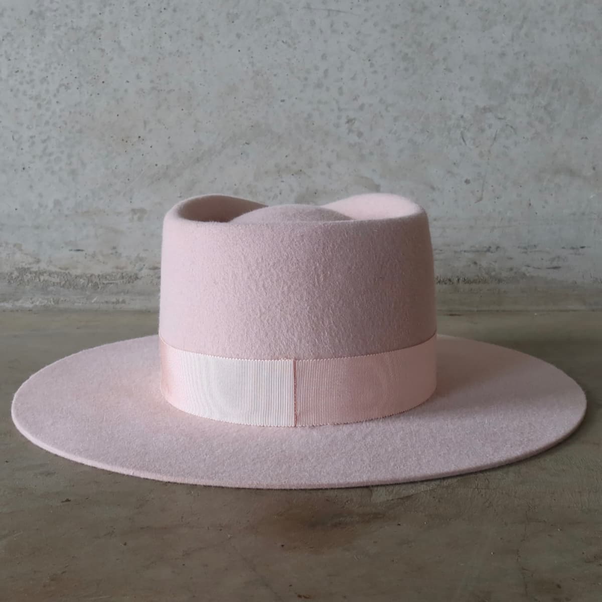 Back view of the baby pink hat Core Baby Pink by PHYLLi Designs featuring interchangeable salmon Japanese grosgrain band.