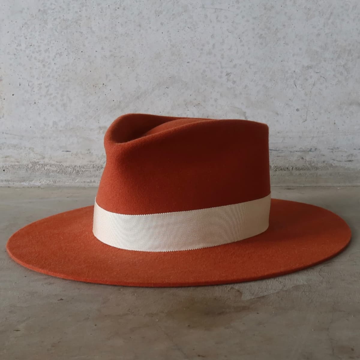 Front left angle of the spiced pumpkin hat Core Spiced Pumpkin by PHYLLi Designs with sand Japanese grosgrain band.