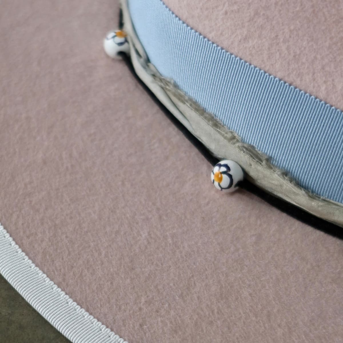 Close up detail of the Daisy felt hat showing ivory brim stitch and ivory grosgrain brim trim.