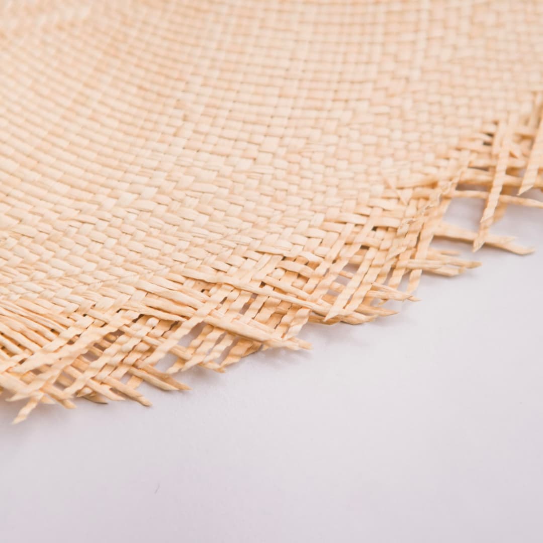 Close up detail of the Delfina Panama hat showing handwoven toquilla straw Panama weave.