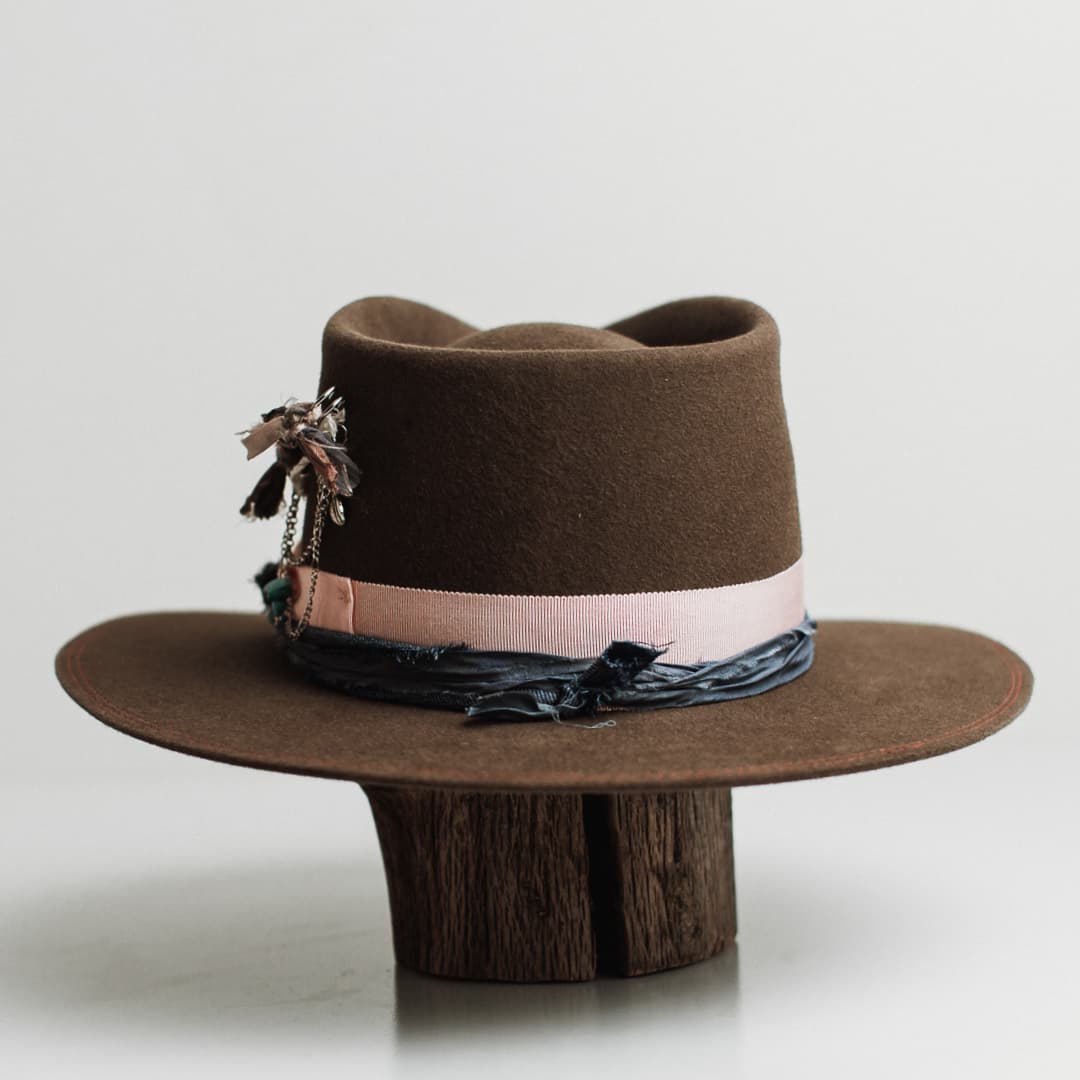 Back view of the Denman dirty olive felt hat by PHYLLi Designs featuring double brim stitch in watermelon and denim sari silk trimming.