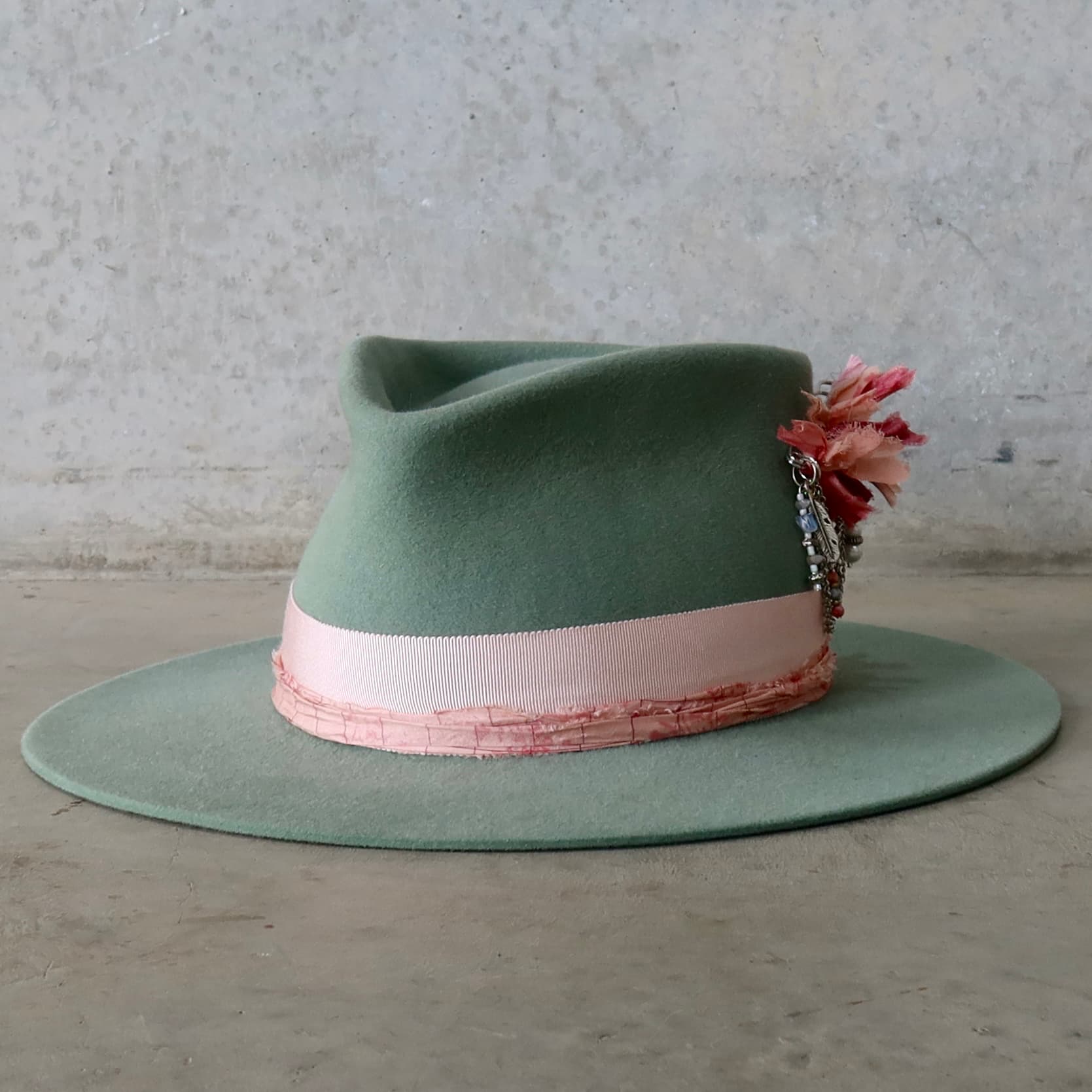 Front left angle of the Eucalyptus felt hat Diamonds & Pearls – Pink by PHYLLi Designs with Sherbet Pink Japanese grosgrain band and strawberry sari silk trim.