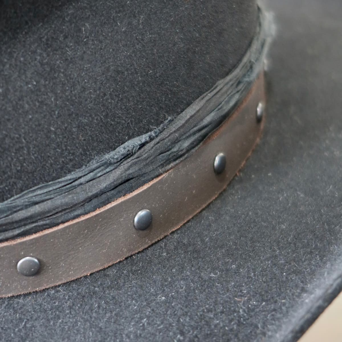 Close up detail of the Edwards felt cowboy hat showing buffalo leather studded hat band.