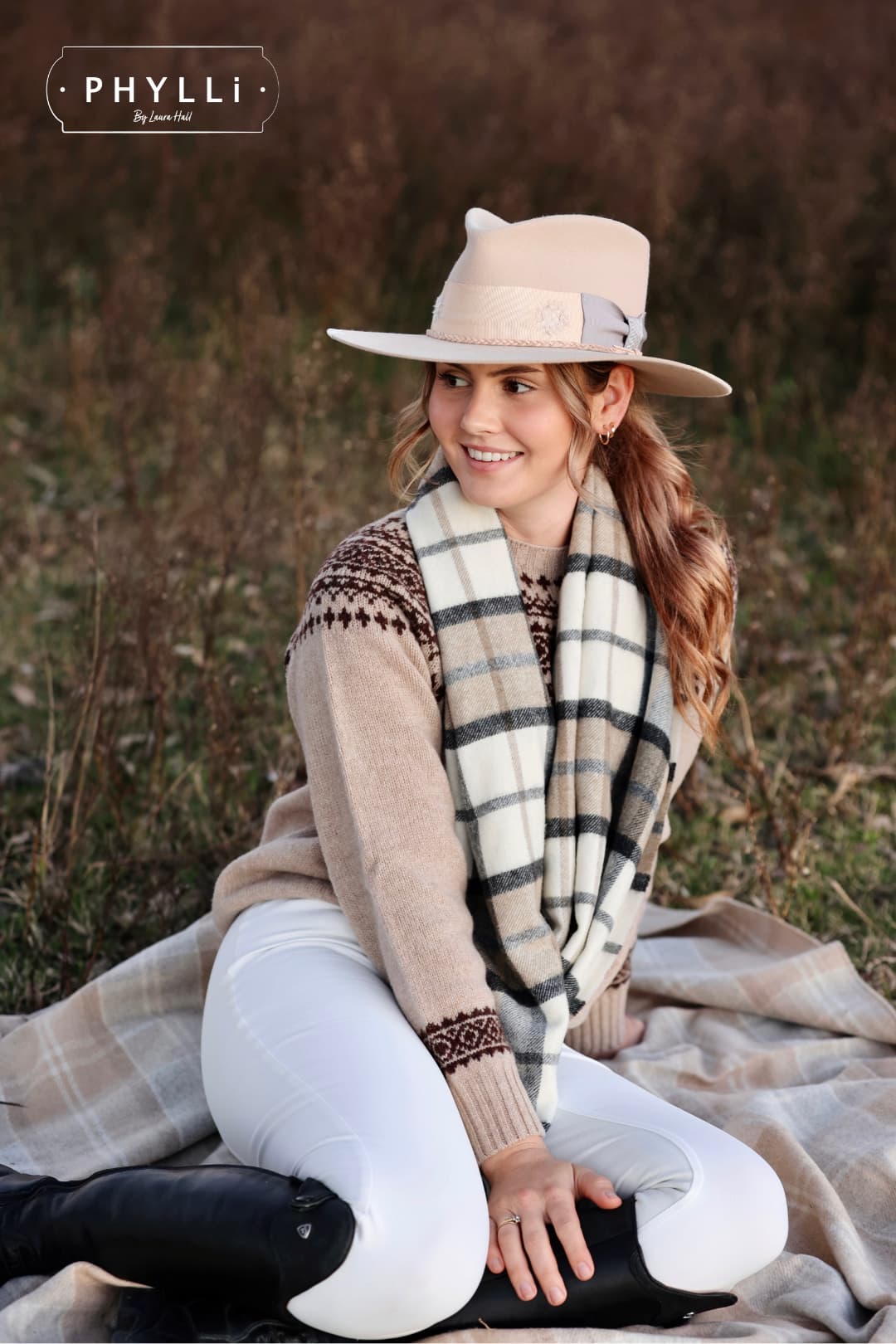 Woman wearing Fallon beige felt hat by PHYLLi Designs styled with knit sweater and scarf outdoors.