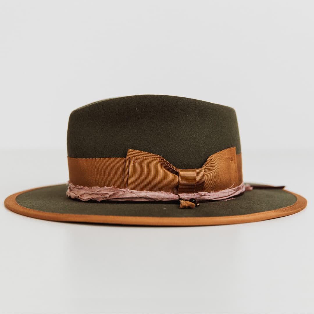 Left side view of the Feuille Morte Military felt hat by PHYLLi Designs with charm cluster and sari silk trim.