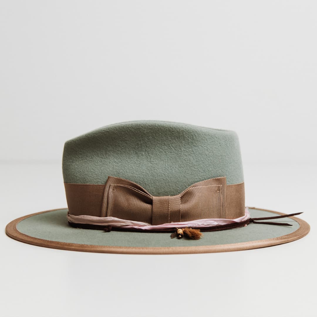 Side view of Feuille Morte Sage felt hat with taupe grosgrain band and rose sari silk trim.