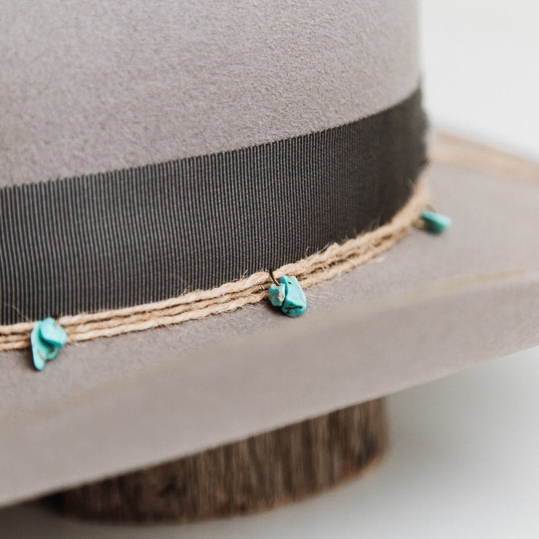 Close up detail of the Finse felt hat showing distressed rabbit felt texture and turquoise bead trim.