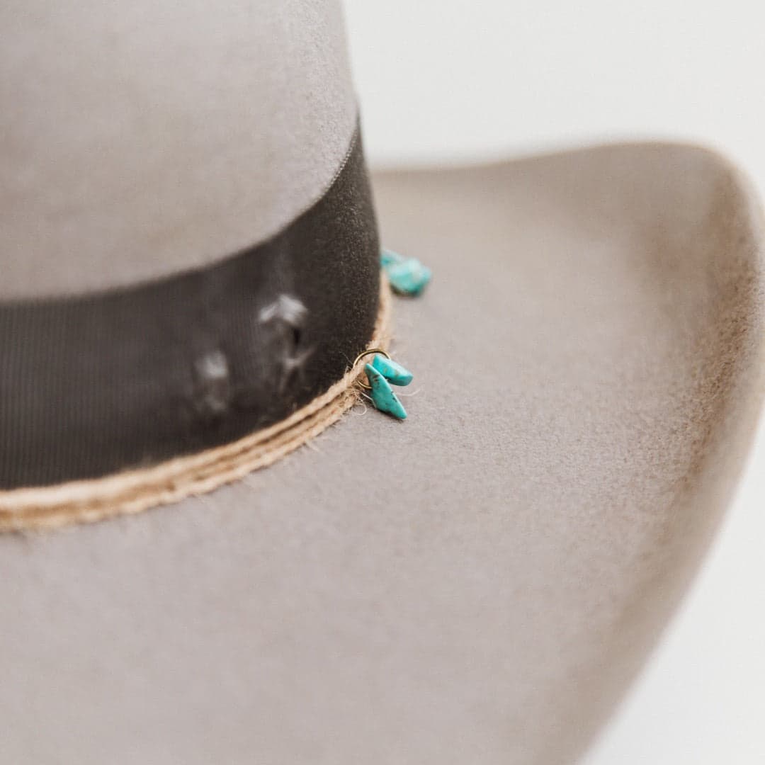 Close up detail of the Finse felt hat showing three twine wraps with turquoise bead accents.