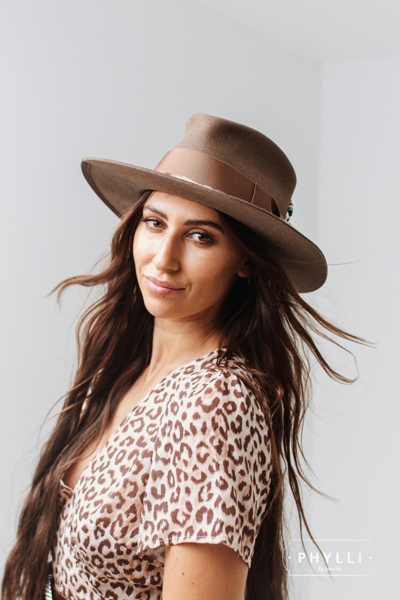 Woman wearing the Fly Fisher Havana felt hat by PHYLLi Designs featuring chunky hat pin and sari silk.