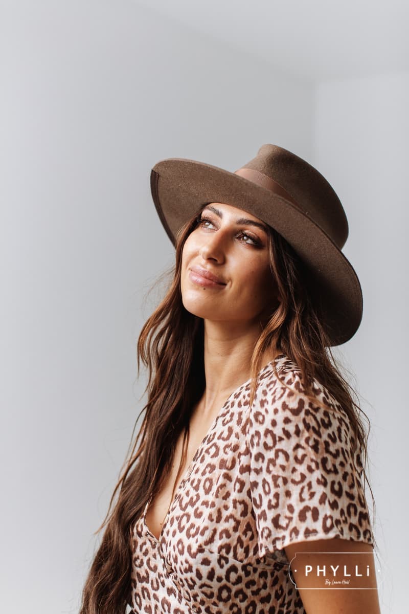 Woman wearing the Fly Fisher Havana felt hat by PHYLLi Designs with praline grosgrain band.