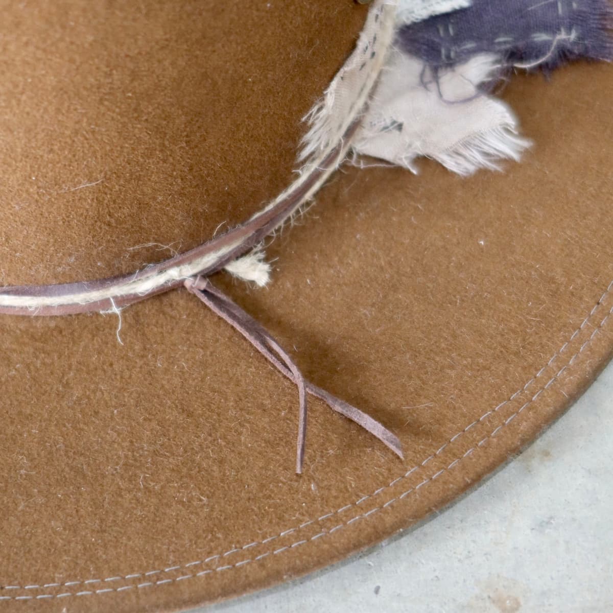 Close up detail of the George Limited Edition felt hat showing partial double brim stitch in grey.