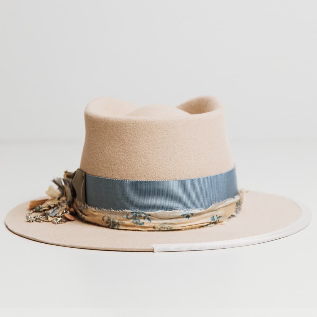 Back view of the Hunter beige felt hat by PHYLLi Designs featuring cream and blue patterned sari silk trim.