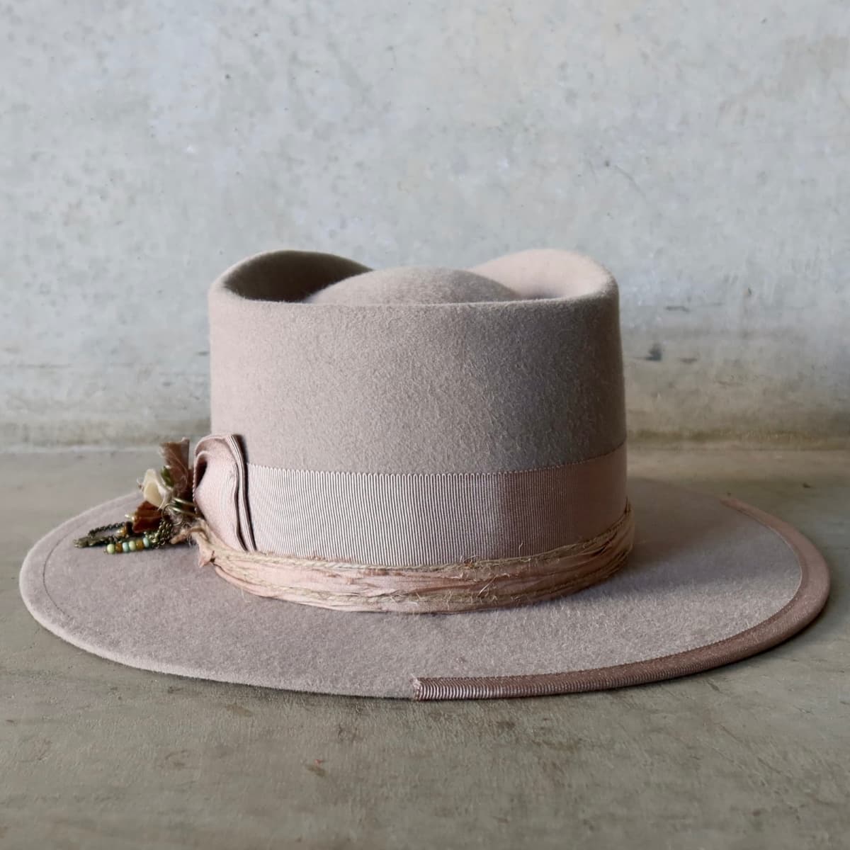 Back view of the Sahara felt hat Huskisson by PHYLLi Designs featuring plaster Japanese grosgrain band and 1/3 brim trim.
