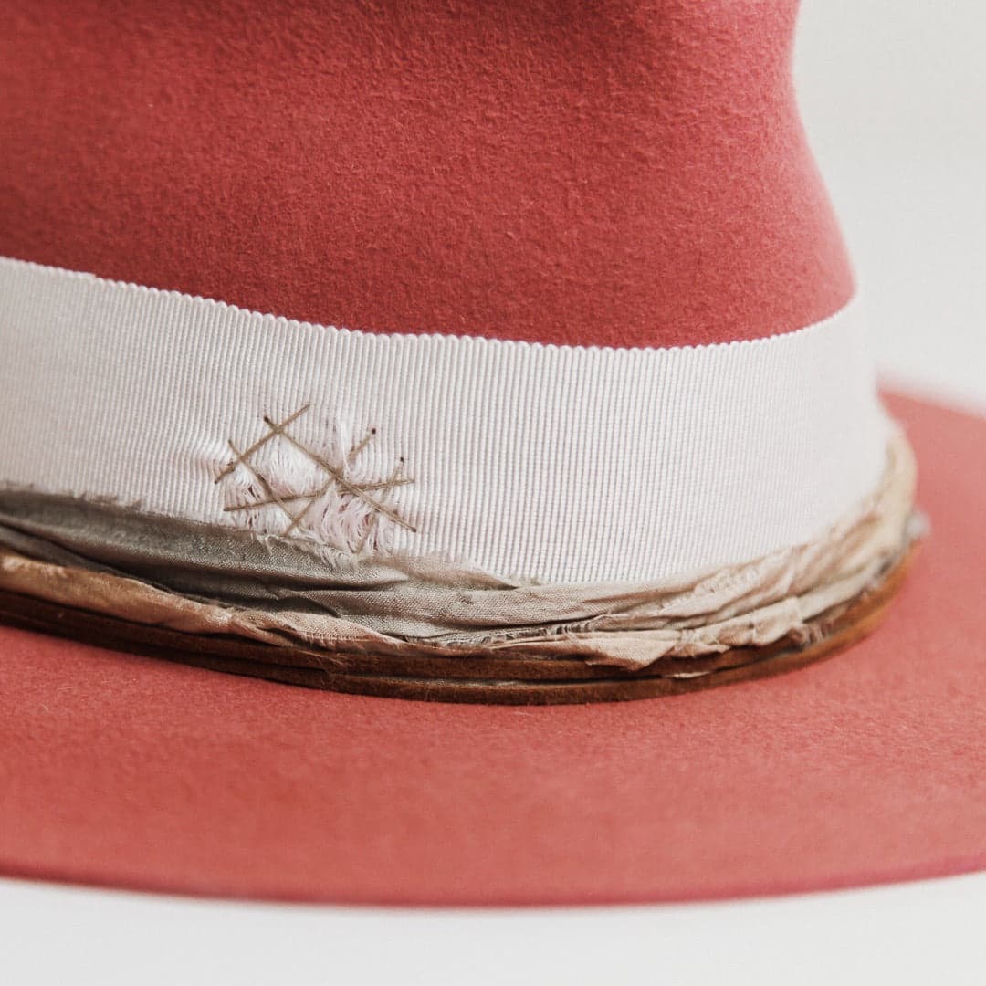 Close up detail of the Kentucky felt hat showing ivory grosgrain band with stone darned patch and peach and pale blue sari silk trimming.