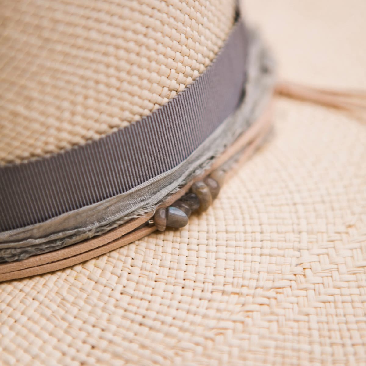 Close up detail of the La Journee Panama hat showing smokey quartz crystal cluster with storm sari silk trim and nude suede string.