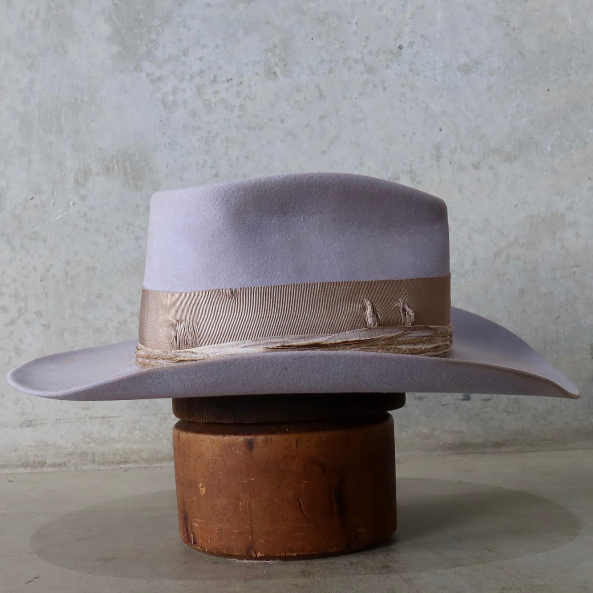 Right side view of the lilac distressed felt cowgirl hat Lacey by PHYLLi Designs with sari silk trimming and twine wraps.