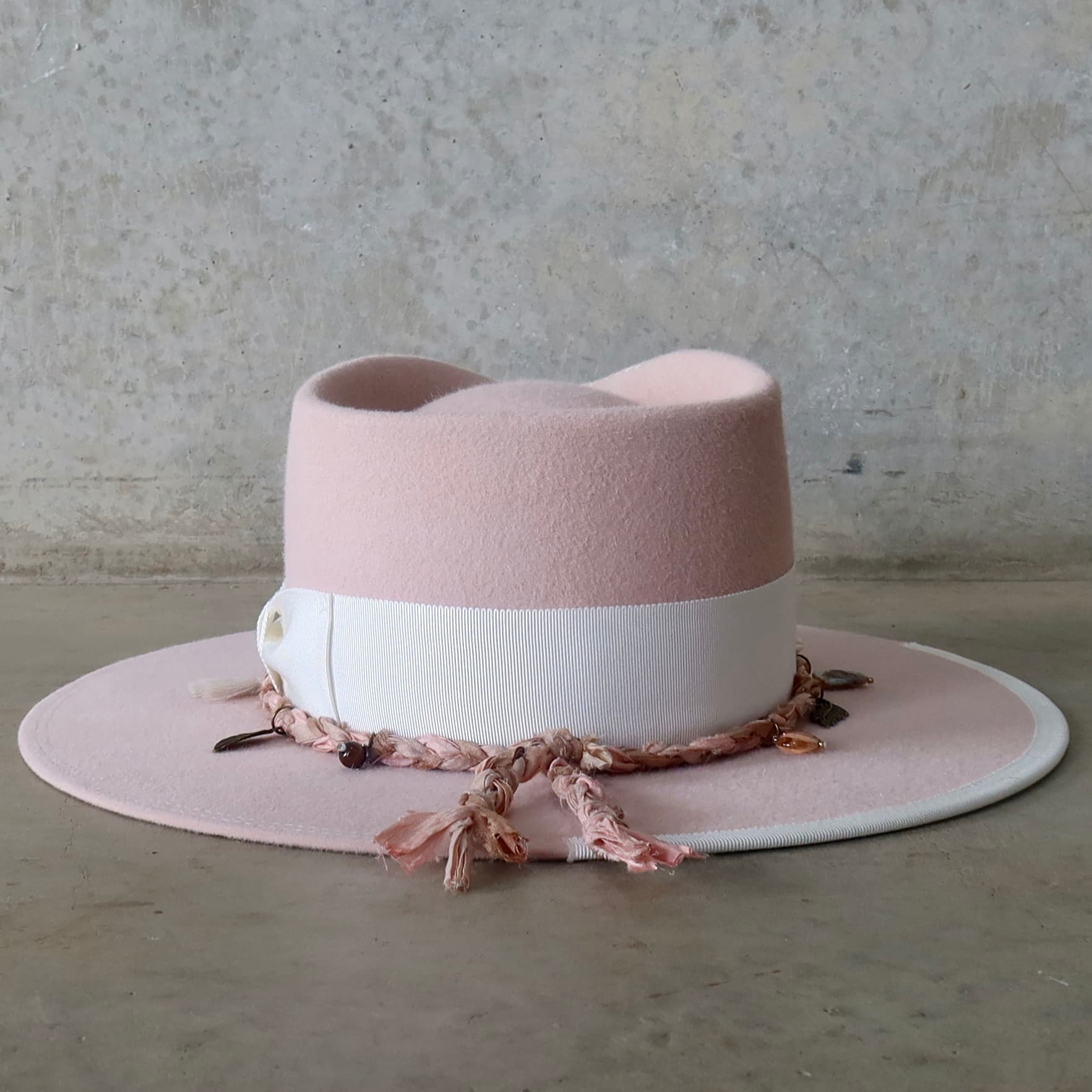 Back view of the baby pink felt hat Lucky Charm by PHYLLi Designs featuring ivory grosgrain brim trim and double brim stitch.