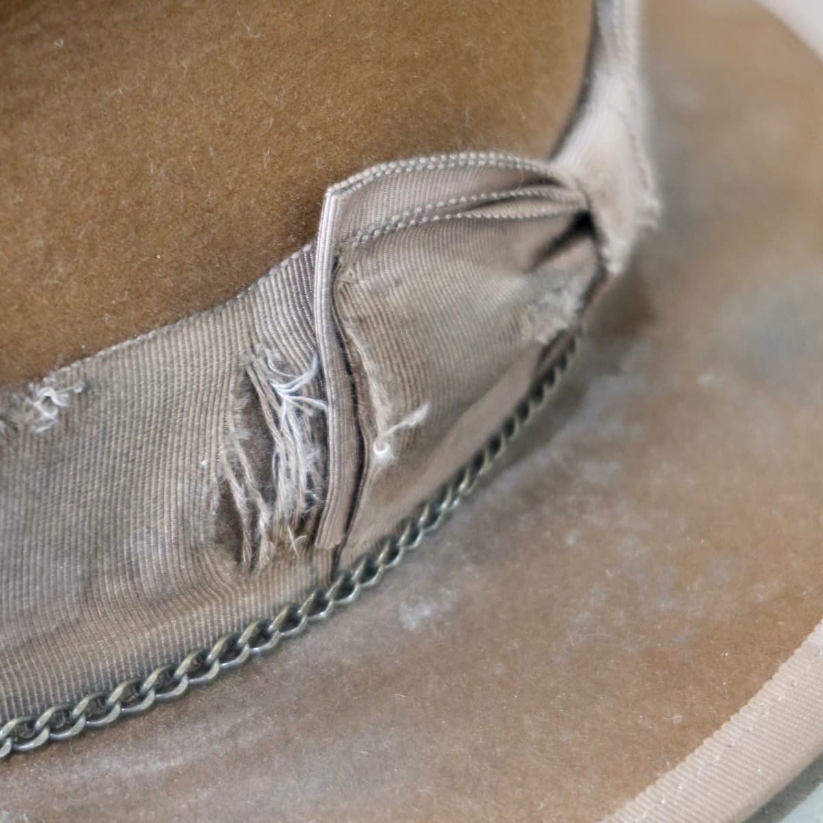 Close up detail of the Marlboro felt hat showing distressed taupe Japanese grosgrain band and double bow stitching.
