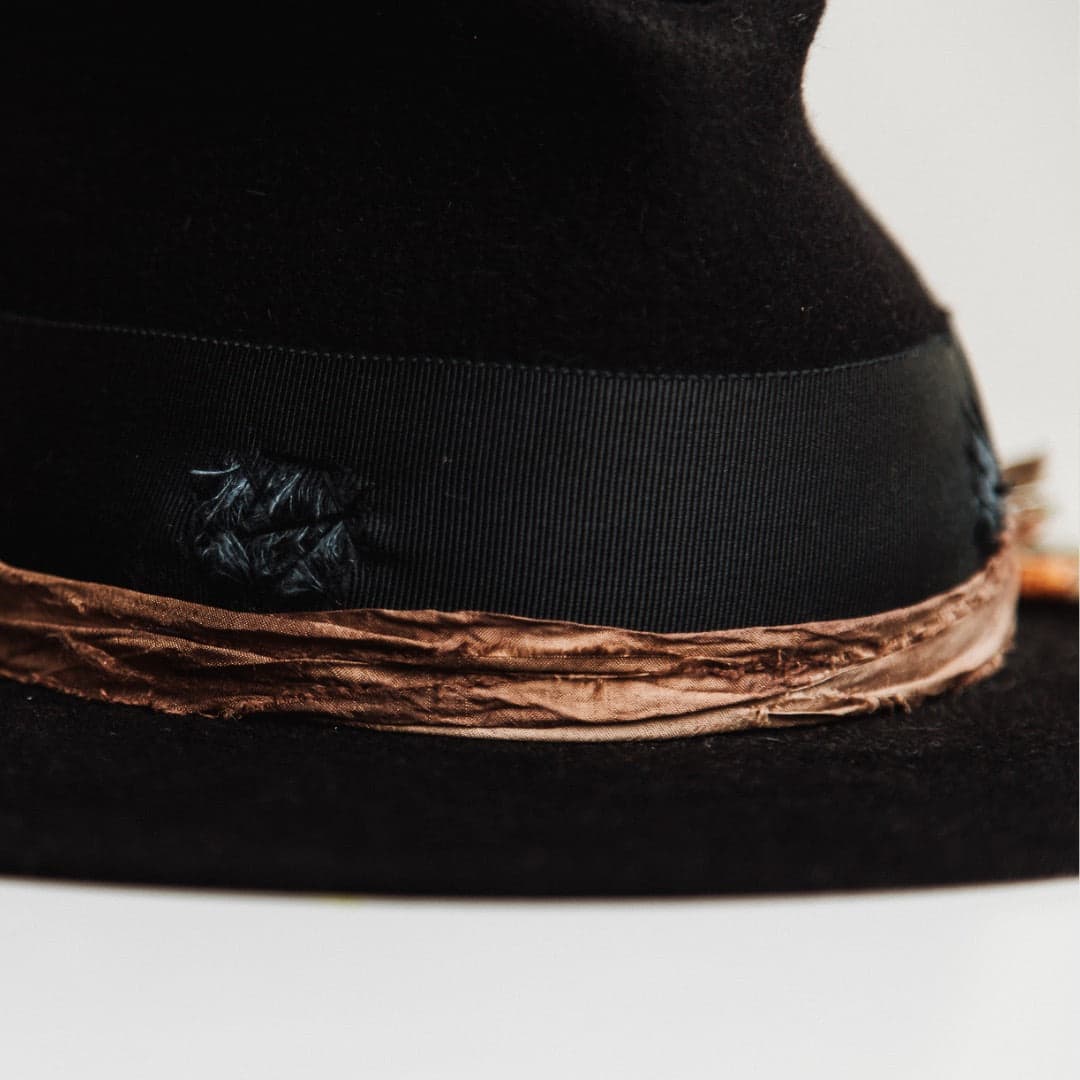 Close up detail of the Newmarket felt hat showing rust sari silk trim wrapped around the crown.