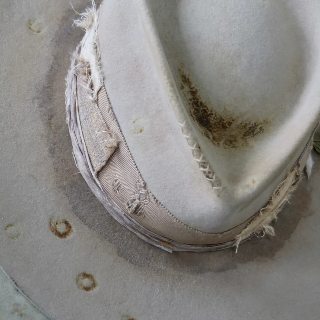 Close up detail of the Oakley Limited Edition felt hat showing distressed Sahara felt with vintage burn markings and worn patchwork trim.