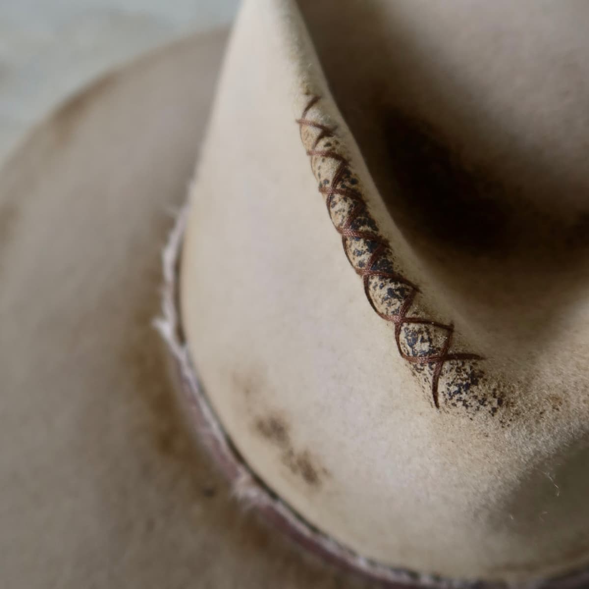 Close up detail of the Old Joe hat showing hand stitched crosses on distressed Sahara rabbit felt.