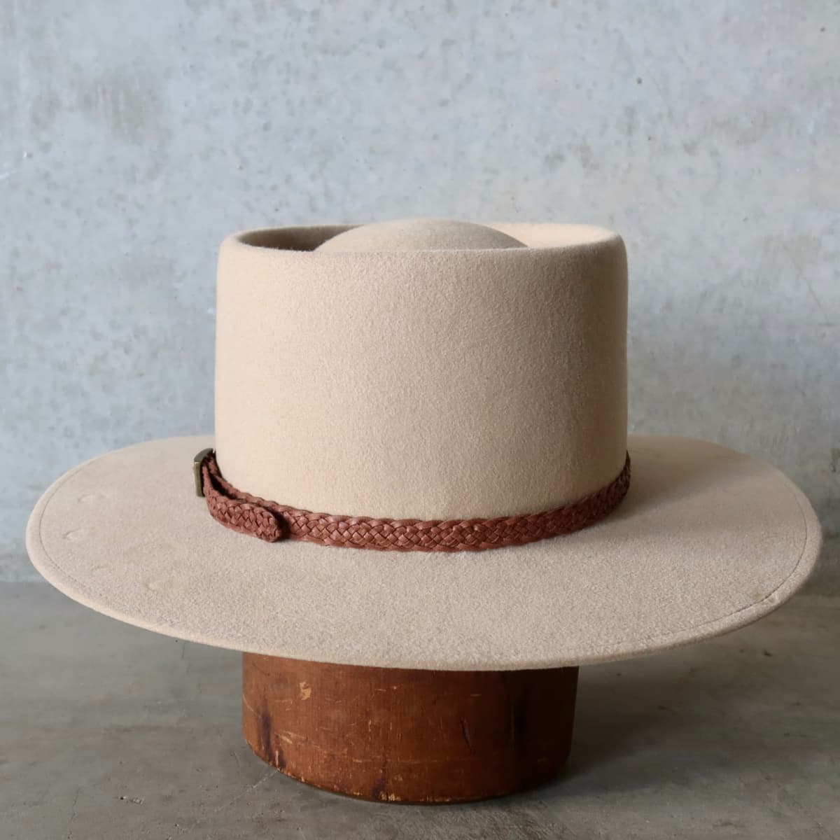Back view of the Sand felt hat Paisley by PHYLLi Designs featuring plaited leather hat band with bronze buckle.
