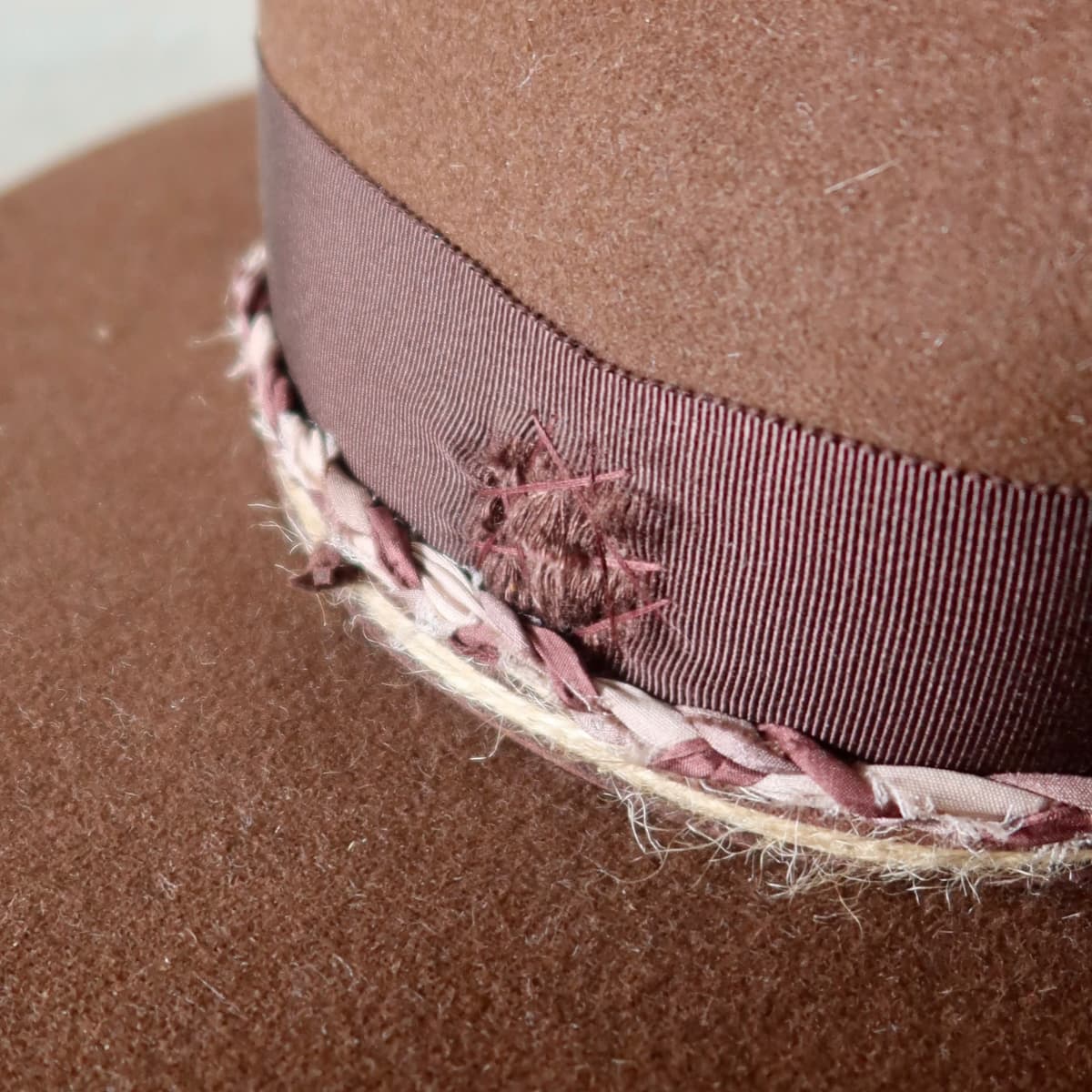 Close up detail of the Palmer Limited Edition felt hat showing plaited sari silk trim with twine wraps.