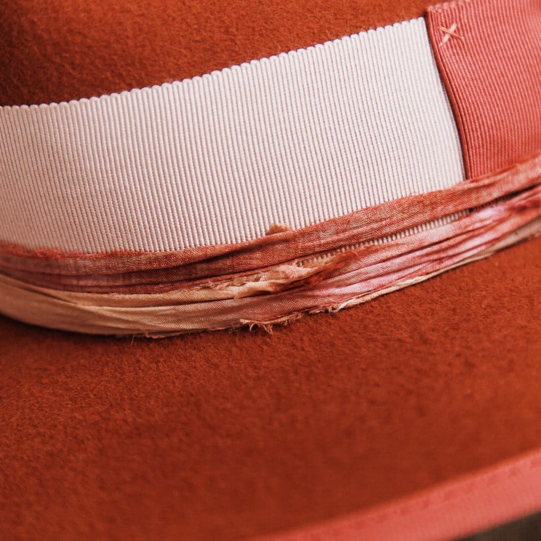 Close up detail of the Pamela felt hat showing pink and mauve tie-dye sari silk trim and watermelon grosgrain brim trim.