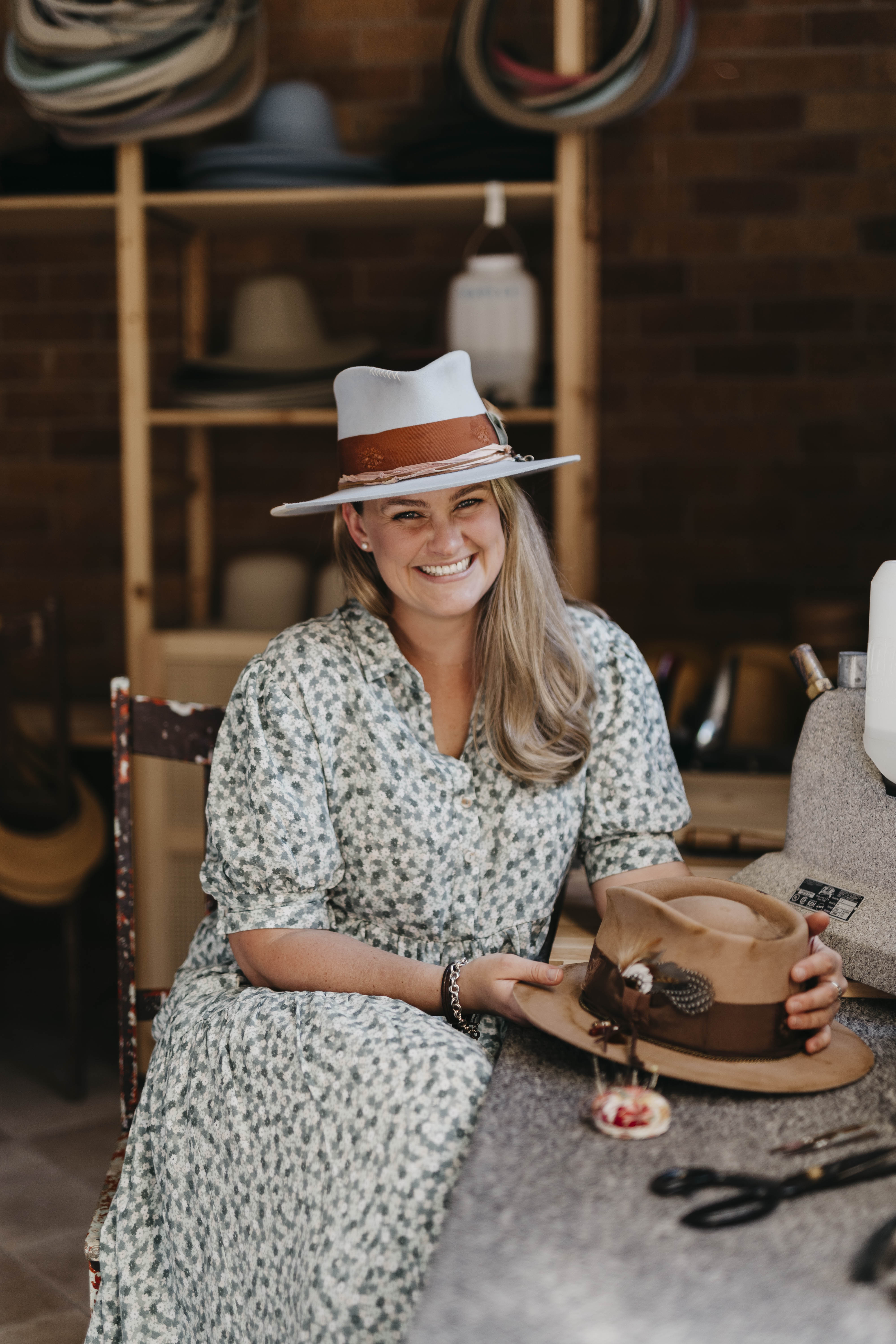 Laura Hall in her studio holding a camel felt hat - founder of PHYLLi Designs sharing the story behind the brand